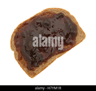 Top view of plum preserves spread on a piece of wheat bread isolated on a white background. Stock Photo