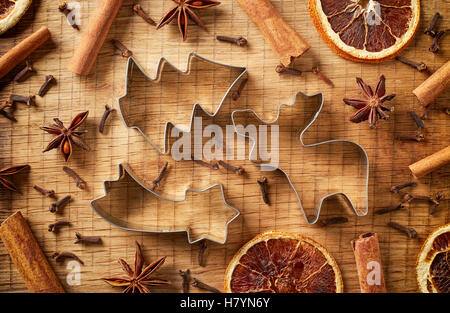Christmas spices and cookie cutters on wooden background, top view Stock Photo