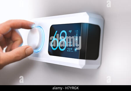 Hand turning a home thermostat knob to set temperature on energy saving mode. fahrenheit units. Composite image between a photog Stock Photo