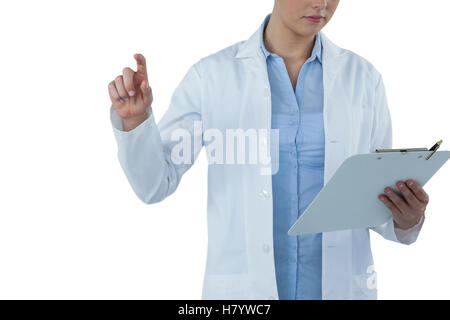 Mid section of female doctor using digital screen while holding clipboard Stock Photo