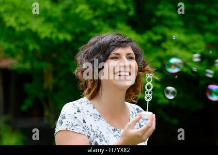 Young woman, blowing bubbles, Upper Bavaria, Bavaria, Germany Stock Photo