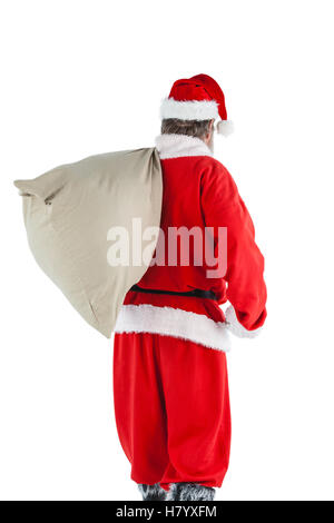 A Santa Claus carrying a bag full of gifts on his back isolated on ...