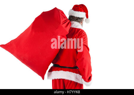 Santa claus carrying bag full of gifts Stock Photo