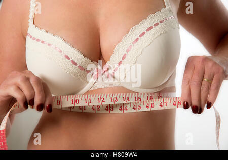 Beautiful Athletic Woman With Tape Measures The Size Of The Breast. Photo  Of Young Woman In Sports Wear On White Background. Strength And Motivation  Stock Photo, Picture and Royalty Free Image. Image