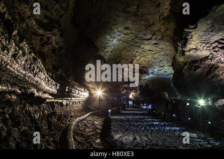 Inside the dark, lit and empty Manjanggul Lava Tube Cave on Jeju Island in South Korea. Stock Photo