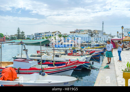 The tourist enjoy the colorful fishing boats in fishing port Stock Photo