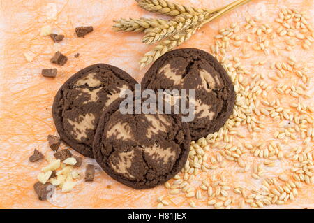Chocolate chip brown cookies on orange background Stock Photo