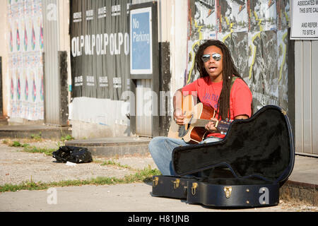 Street musician playing guitar Stock Photo