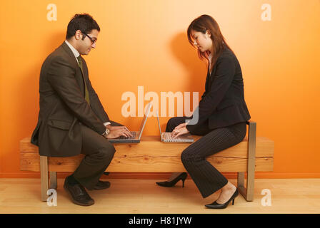 woman and man working on laptops Stock Photo