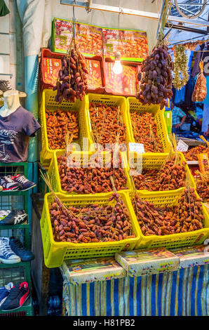 The local grocery offers the wide range of the dried dates on branches and in gift boxes Stock Photo