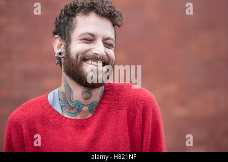 Portrait of a friendly tattooed man in his 30s Stock Photo