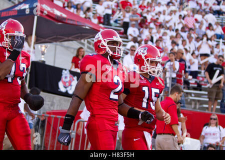 Sep. 18, 2009; Fresno, CA, USA; Fresno State Bulldogs wide receiver Seyi Ajirotutu (2) and quarterback Ryan Colburn (15) and defensive tackle Chris Carter (43) head out for the coin toss before the Boise State Broncos game at Bulldog Stadium. Boise State Stock Photo