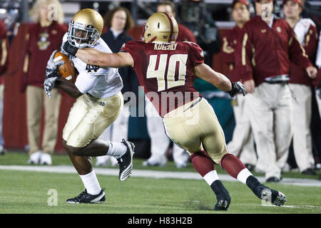 October 2, 2010; Chestnut Hill, MA, USA;  Notre Dame Fighting Irish wide receiver Theo Riddick (6) breaks a tackle from Boston College Eagles linebacker Luke Kuechly (40) during the fourth quarter at the Alumni Stadium.  Notre Dame defeated Boston College Stock Photo