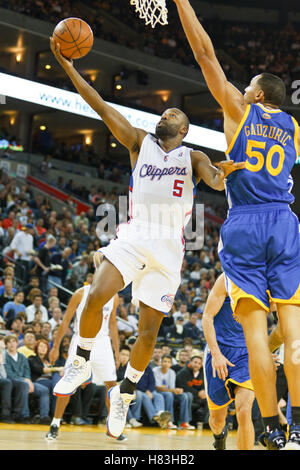 October 29, 2010; Oakland, CA, USA;  Los Angeles Clippers point guard Baron Davis (5) shoots past Golden State Warriors center Dan Gadzuric (50) during the second quarter at Oracle Arena. Stock Photo