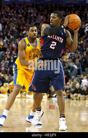 February 25, 2011; Oakland, CA, USA;  Atlanta Hawks shooting guard Joe Johnson (2) is defended by Golden State Warriors small forward Reggie Williams (55) during the second quarter at Oracle Arena. Stock Photo