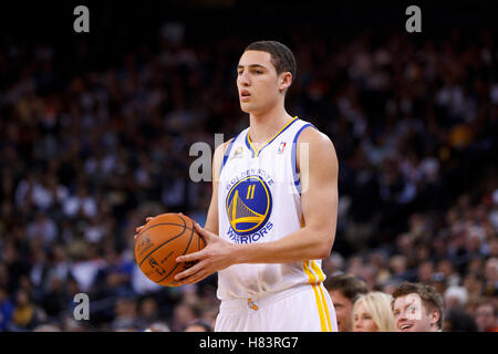 Feb 2, 2012; Oakland, CA, USA; Golden State Warriors guard Klay Thompson (11) holds the ball against the Utah Jazz during the second quarter at Oracle Arena. Golden State defeated Utah 119-101. Stock Photo