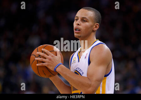 Feb 15, 2012; Oakland, CA, USA; Golden State Warriors point guard Stephen Curry (30) holds the ball against the Portland Trail Blazers during the third quarter at Oracle Arena. Portland defeated Golden State 93-91. Stock Photo