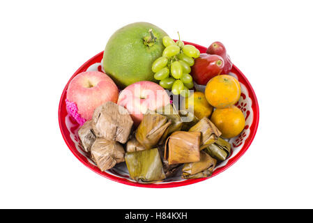 Isolated tray of assorted fruit, Nian gao and Stuffed Dough Pyramid Dessert for Chinese new year celebration Stock Photo