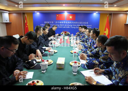 Haikou. 8th Nov, 2016. Members of coast guard from China and Vietnam communicate on a China Coast Guard ship in a common fishing zone in the Beibu Gulf, Nov. 8, 2016. China and Vietnam concluded a three-day joint patrol mission in a common fishing zone in the Beibu Gulf Wednesday. Coast guards from both sides completed a series of scheduled tasks, including a joint patrol, maritime search and rescue exercise, and examination of fishing boats, amid strong winds and high waves, according to a China Coast Guard (CCG) statement. © Bai Guolong/Xinhua/Alamy Live News Stock Photo