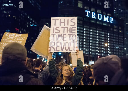 Chicago, Illinois, USA. 9th November, 2016. A protestor holds a sign reading 'This is the time to revolt' in front of Trump tower in a anti-trump protest. Credit:  Caleb Hughes/Alamy Live News. Stock Photo