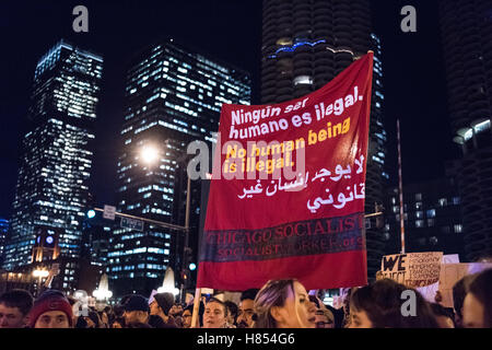 Chicago, Illinois, USA. 9th November, 2016. Chicago Socialists hold a sign reading 'No Human Being is illegal' in Spanish, English and Arabic. At the November 9th protest against Donald Trump. Credit:  Caleb Hughes/Alamy Live News. Stock Photo
