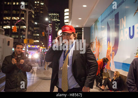 New York, NY, USA - 9th November 2016. 3:50 AM: a Trump supporter talks on the phone while hanging in front of the midtown Hilton Hotel, where the Trump campaign organized its election night party. Photo: Alessandro Vecchi dpa