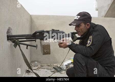 Mosul, Nineveh, Iraq. 10th Nov, 2016. 10/11/2016. Mosul, Iraq. An Iraqi SWAT Police officer aims his PKM machine gun towards Islamic State held Mosul, some 700 metres away, from a position in the cities Gogjali District. Credit:  ZUMA Press, Inc./Alamy Live News Stock Photo