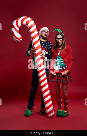 Weird Christmas couple with candy cane Stock Photo