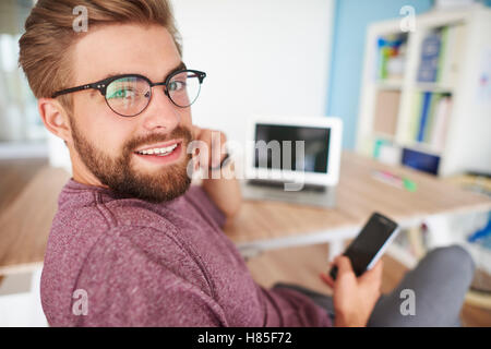 Multi tasking man in home office Stock Photo