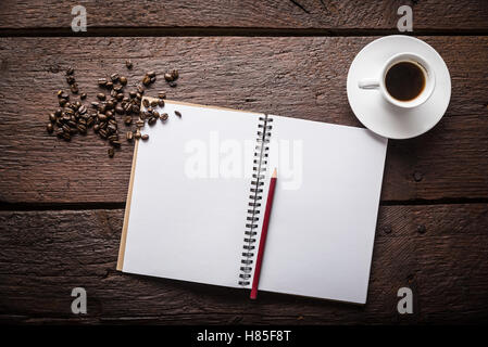 Blank, opened notepad, pencil, cup of coffee and beans Stock Photo