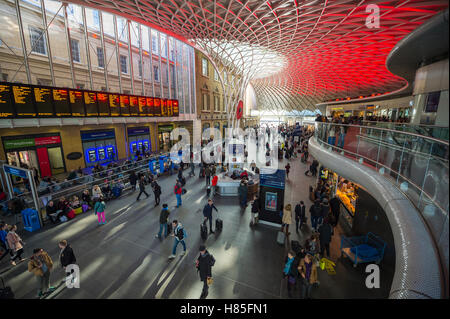 LONDON - NOVEMBER 6, 2016: Travelers pass through the new departures concourse at King's Cross railway station. Stock Photo