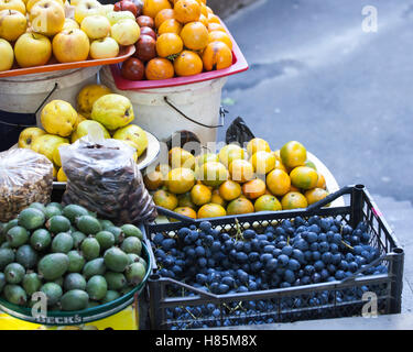 grapes, quince, tangerines, figs in containers for sale in a vegetable shop in Tbilisi Stock Photo