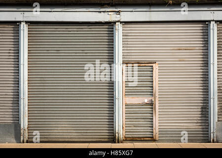 A building secured by metal roller shutters in Cambridge Uk Stock Photo
