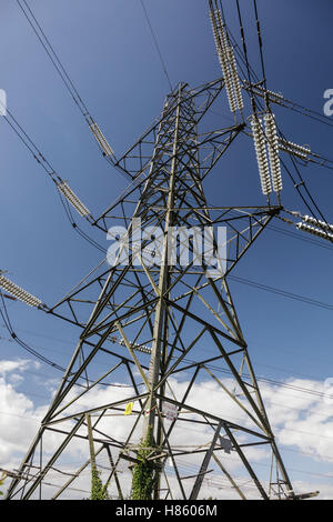 View looking up from underneath a mains electricity pylon and cables near Cirencester Stock Photo