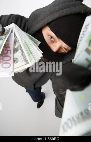 Burglar in gloves with money Stock Photo