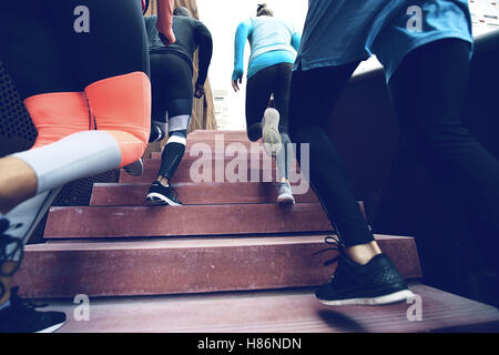 Close up view of several athletes running up the stairs while practising. Copyspace Stock Photo
