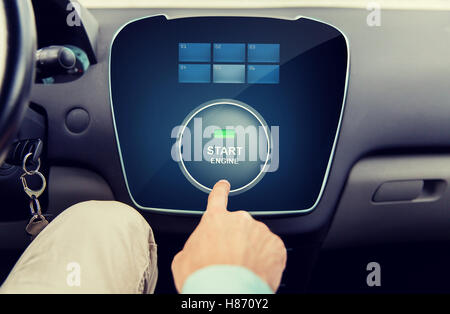 close up of man using starter application in car Stock Photo