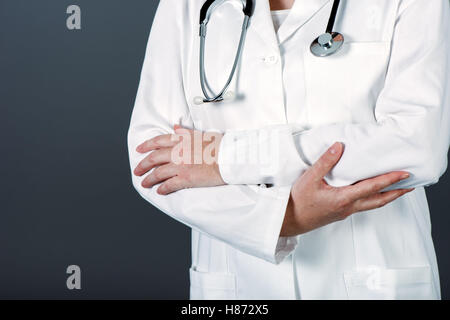 Unrecognizable female doctor posing confident in white medical uniform, general practitioner with stethoscope in hospital clinic Stock Photo