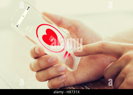 close up of hand with heart rate on smartphone Stock Photo