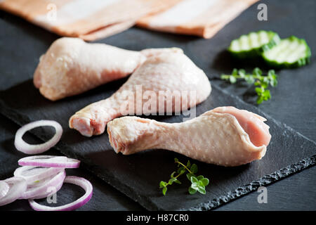 Three raw chicken drumsticks ready to be cooked Stock Photo