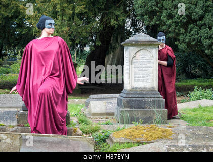 Two young women actors playing the witches from Shakespeare's Macbeth in a graveyard in Clifton Bristol UK Stock Photo