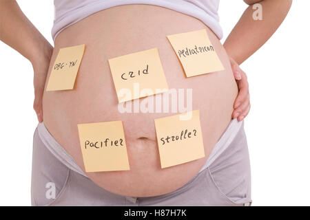 Рregnant belly and sticker notes, woman planning tasks isolated on white. Clipping path inside Stock Photo