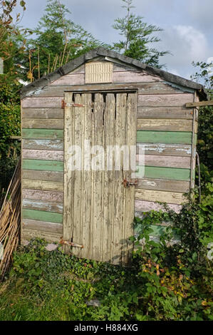 A weather-beaten garden shed. Stock Photo