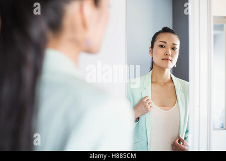A business woman preparing for work, waking up and dressing. Stock Photo