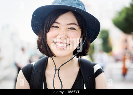Portrait of a smiling young woman wearing a hat. Stock Photo