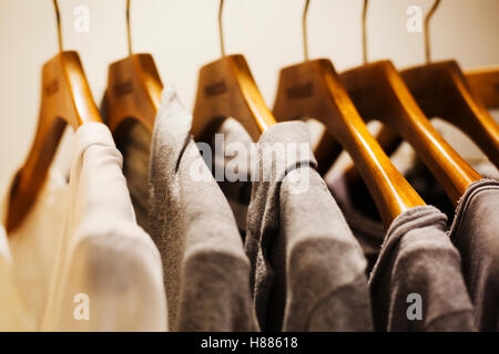 Row of clothes on wooden hangers in a fashion boutique in Tokyo, Japan. Stock Photo