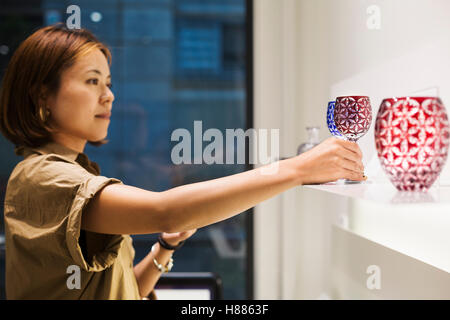 Customer in a shop selling Edo Kiriko cut glass in Tokyo, Japan. Stock Photo