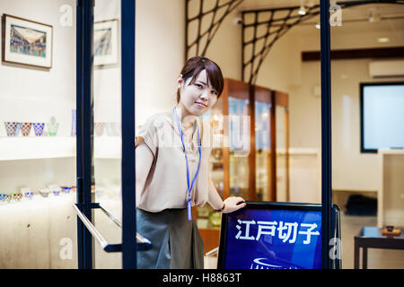 Saleswoman in a shop selling Edo Kiriko cut glass in Tokyo, Japan. Stock Photo