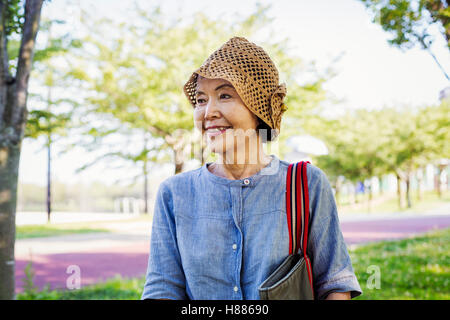 Portrait of a smiling senior woman wearing a crochet hat. Stock Photo