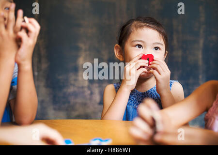 A group of children in school. Two boys and two girls holding up alphabet letters. Stock Photo